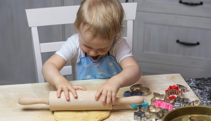 Little girl baking cookies.