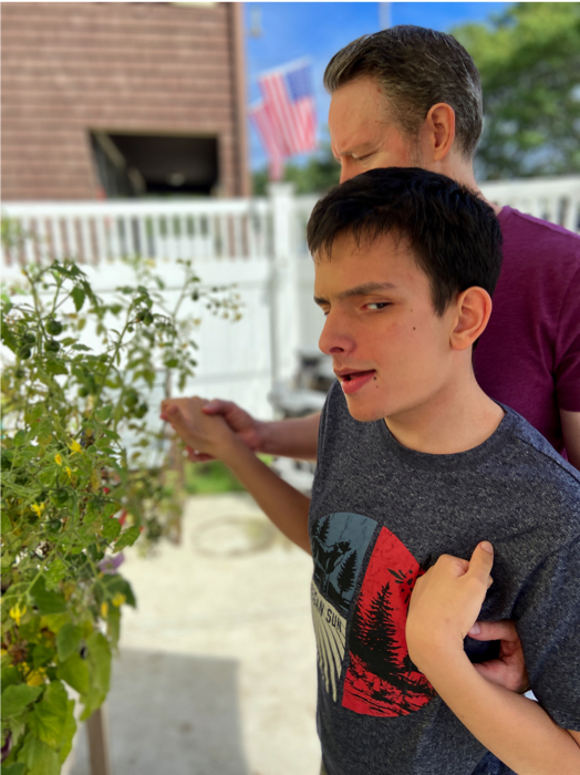 Ivan and his dad picking tomatoes.