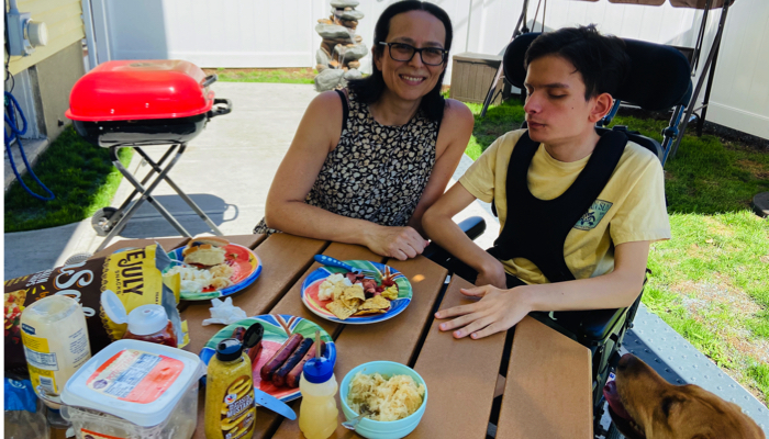 Ivan and his mom at his accessible picnic table.