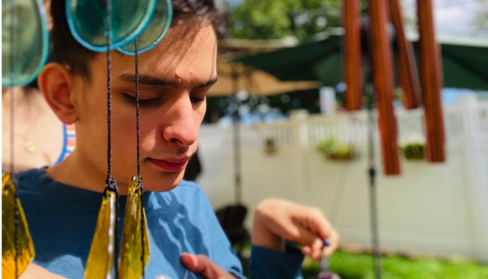 Ivan touching wind chimes.