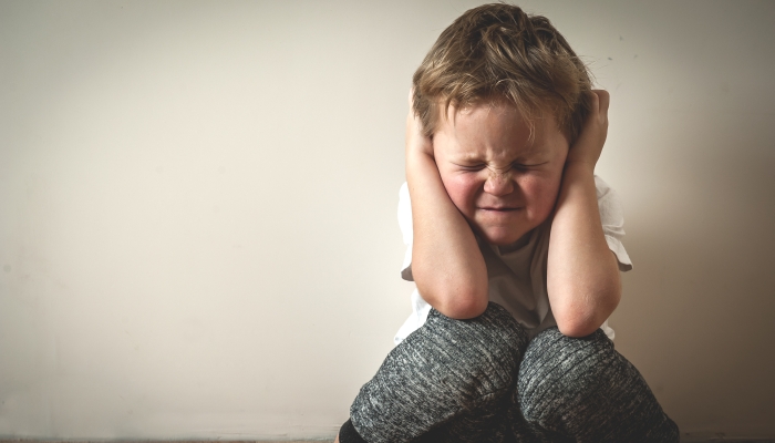 Boy shouts covered his ears with his hands