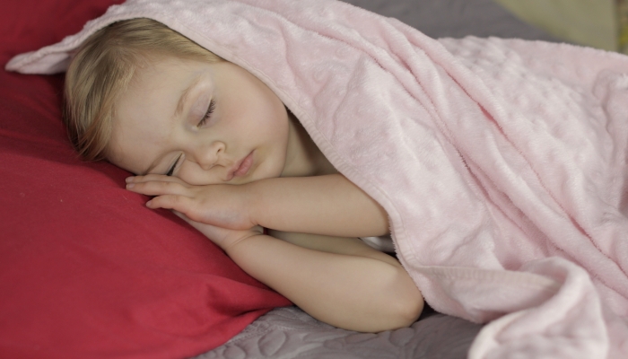 Little girl sleeping in morning light.