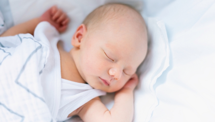 Sleeping newborn in the crib.