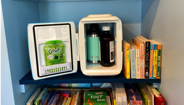 Our Cooluli mini fridge on a box shelf, with the door open.