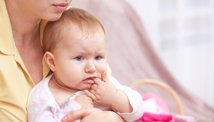 A young woman with her child playing with her teeth