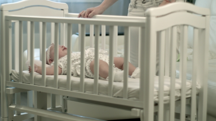 Sleepy baby in the crib