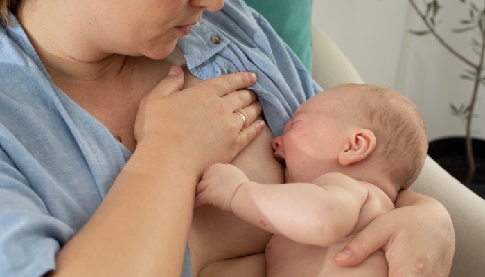 Crying baby while breastfeeding.