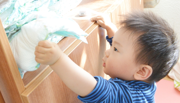 Little boy with his diaper in hand.