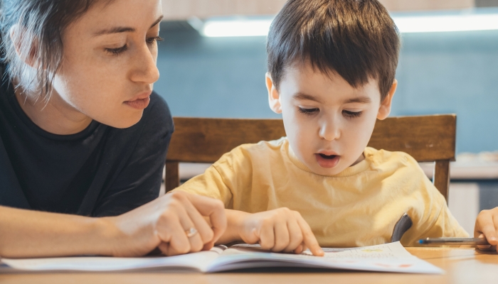 Mother teaching her child to read.