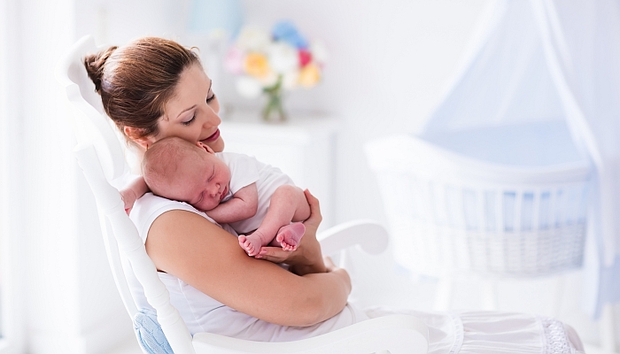 Young mother holding her newborn child.