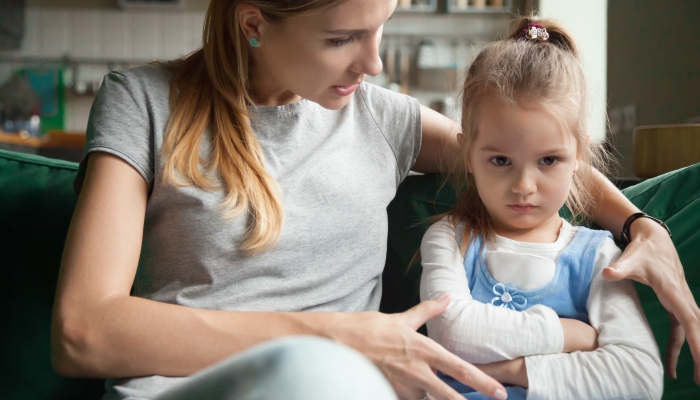 Angry offended little girl ignoring not listening mother word.