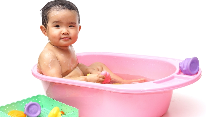 Bath for a young asian baby.