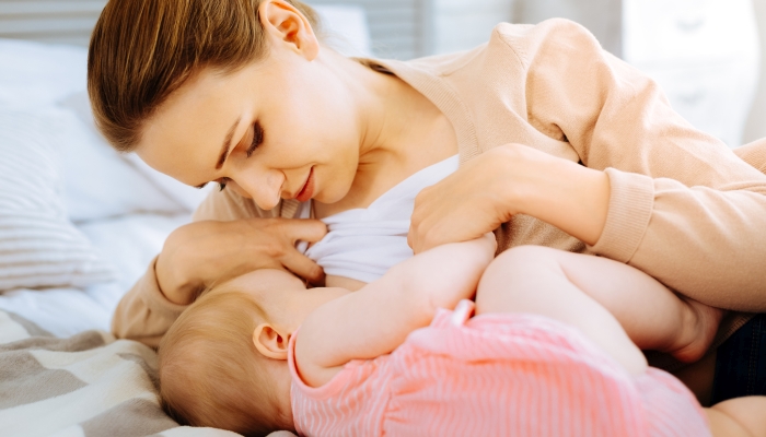 Concentrated mother during breastfeeding her baby.