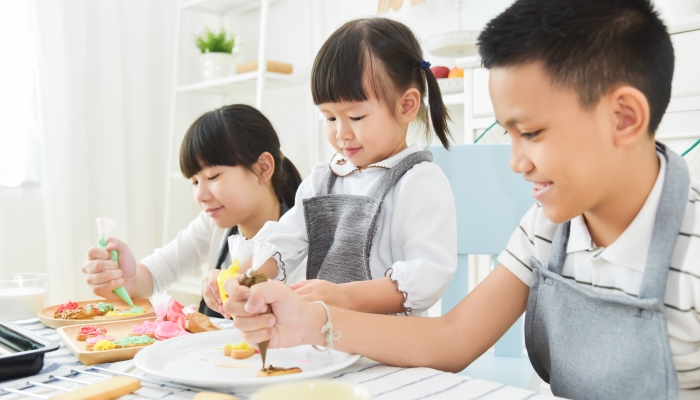 Kids decorating cookies.