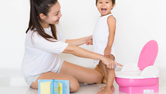 Mother successfully teaches child potty training.