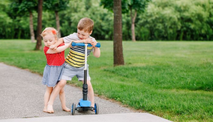 Children fighting over scooter.