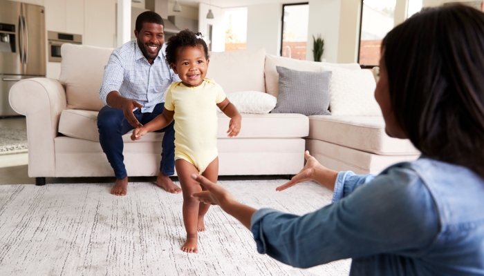 Baby learning to walk at home.