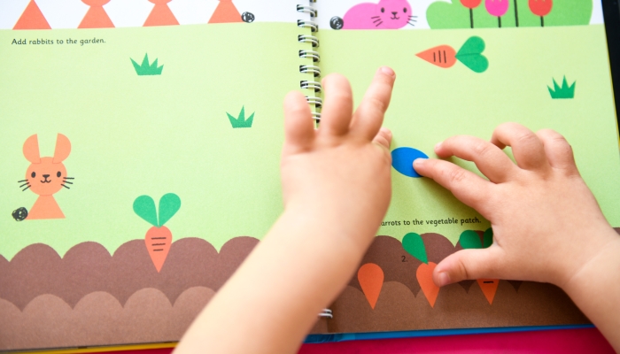 Crafts book on bright colorful pink table.