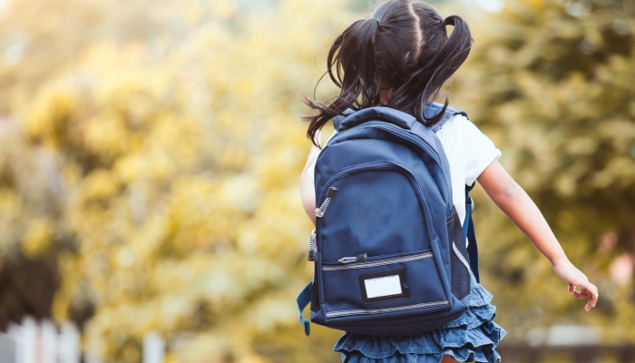 Cute asian child girl with backpack running and going to school with fun.