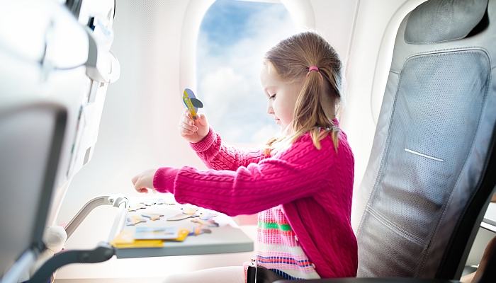 Girl with toy in airplane.