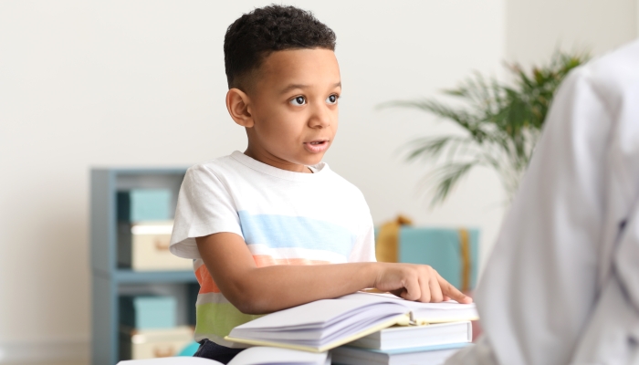 Little boy at speech therapist office.