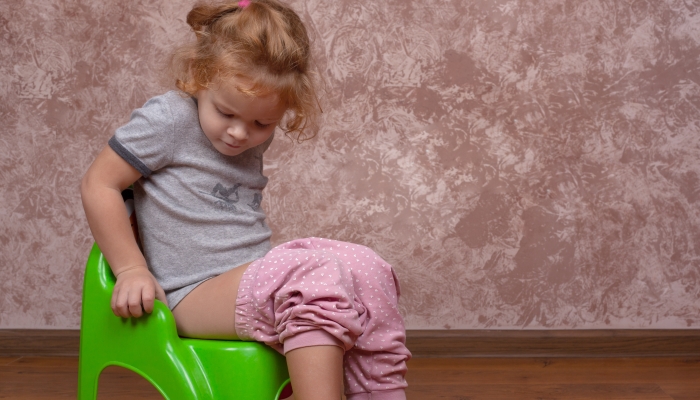 Little girl sitting on the potty,the child learns to go to the toilet on pot.