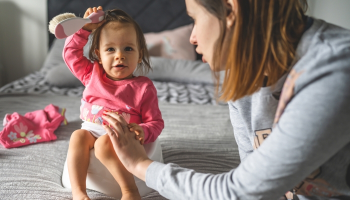 Mother teaching child to use it as toilet.