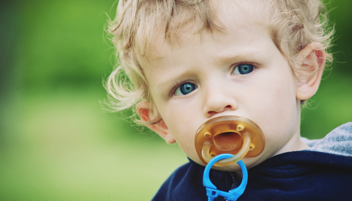 Toddler boy with a pacifier.