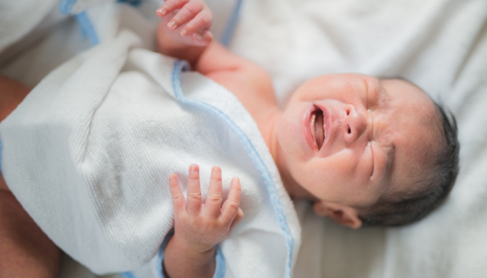 Asian new born baby sleep with crying.