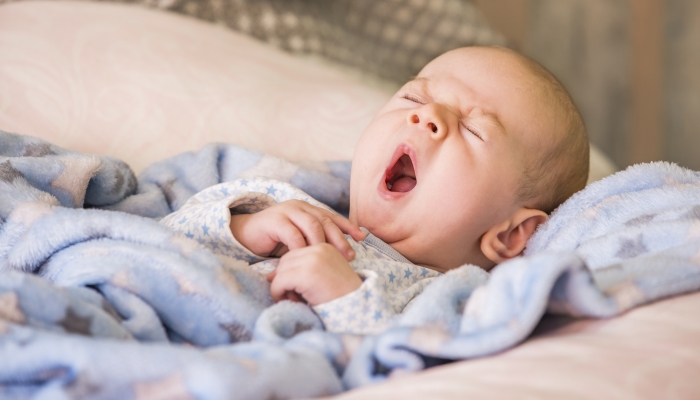 Cute baby yawning before sleep.