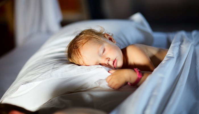 Adorable toddler girl in bedroom at the morning.