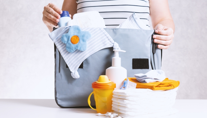 Woman packing diaper bag in maternity hospital.