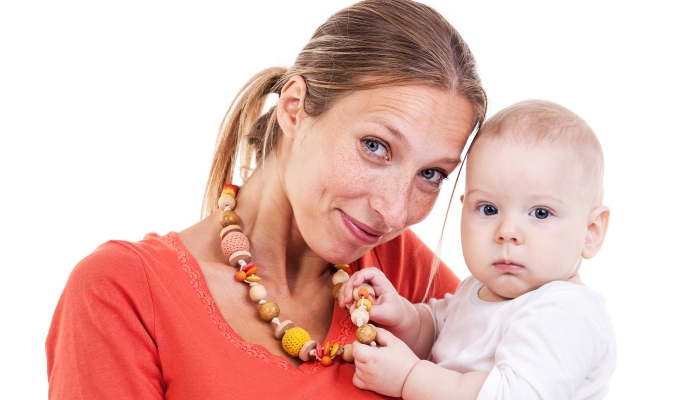 Young Caucasian woman and baby boy with a nursing necklace.