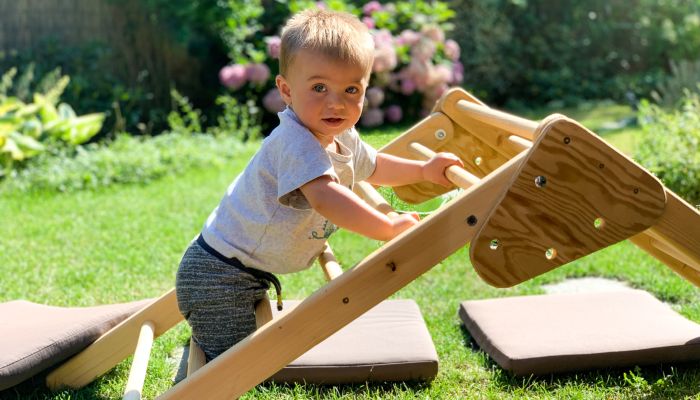 Boy on Pikler triangle.