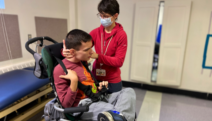 Ivan being measured by his PT for a new stroller.