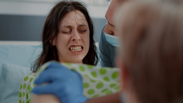 Close up of pregnant woman pushing and screaming.