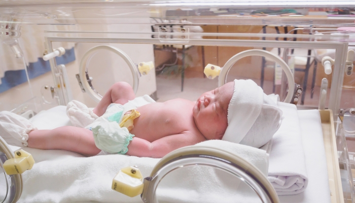 Premature baby infant sleep in the incubator at hospital.