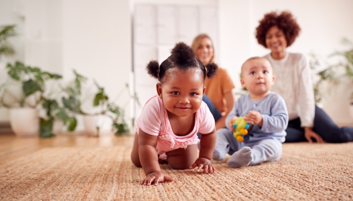 Two Mothers Meeting For Play Date With Babies At Home In Loft Apartment.