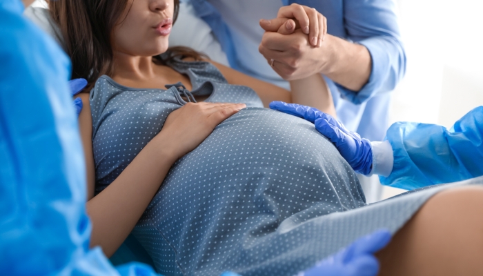 Woman giving child birth in maternity hospital.