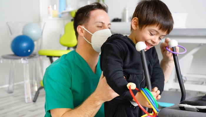 Child with cerebral palsy on physiotherapy in a children therapy center.