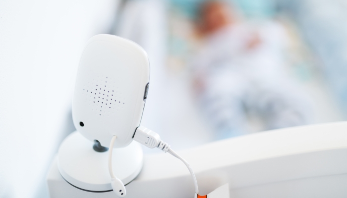 Close up of modern baby monitor on crib.