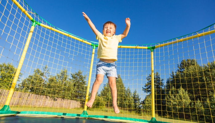 Little boy on a trampoline.