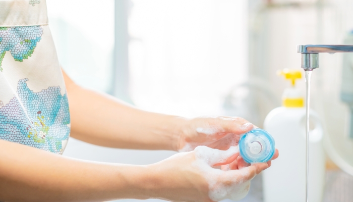 Mother cleaning baby pacifier.