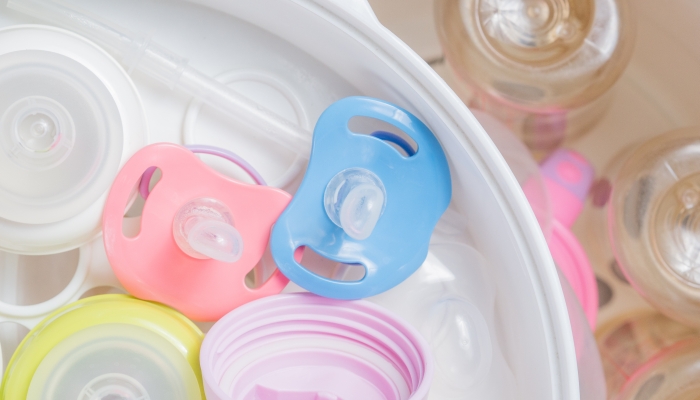 Nipple teethers and milk bottles in steam sterilizer and dryer.