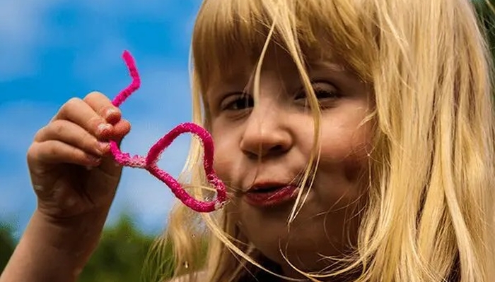 Girl with pipe cleaner bubble wand.