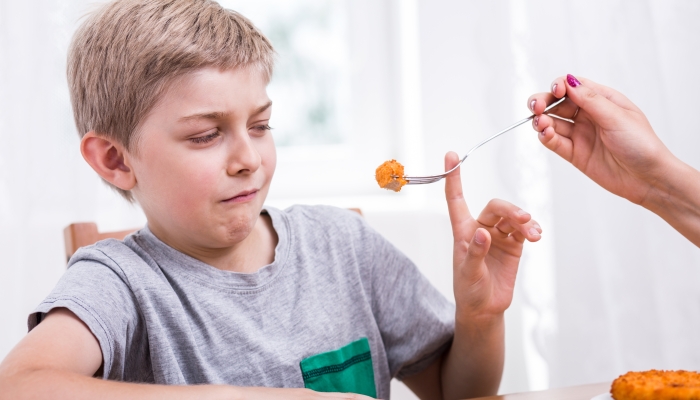 Mother feeding a picky eater son