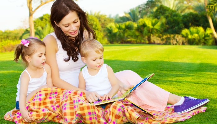 Mother with children read book.