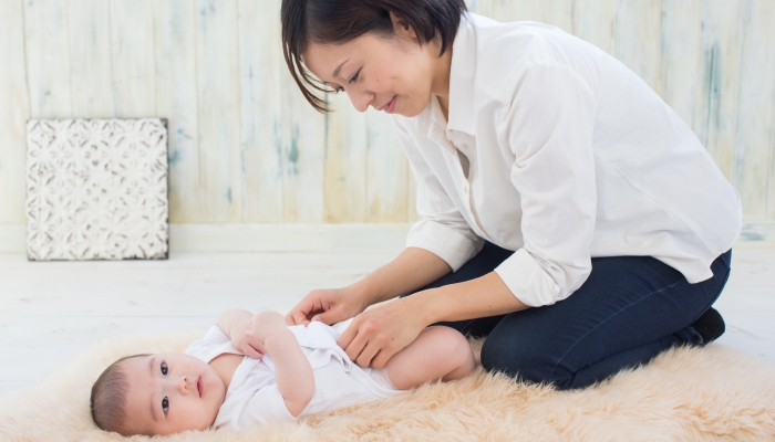 Asian baby and mom changing cloth diaper