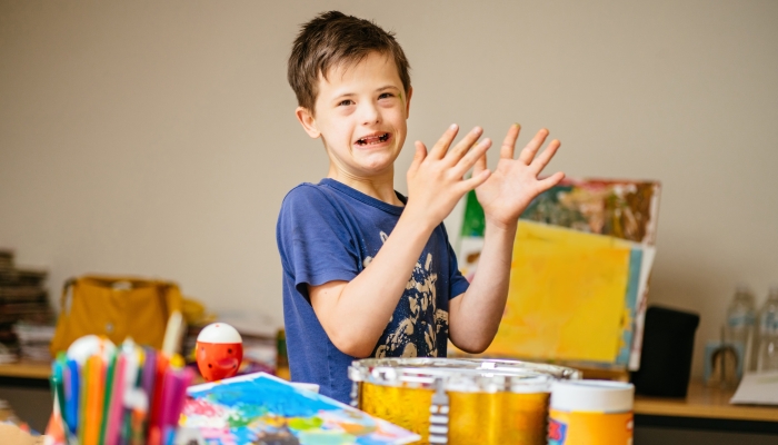 Child boy flapping hands.