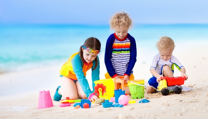 Child playing on tropical beach.